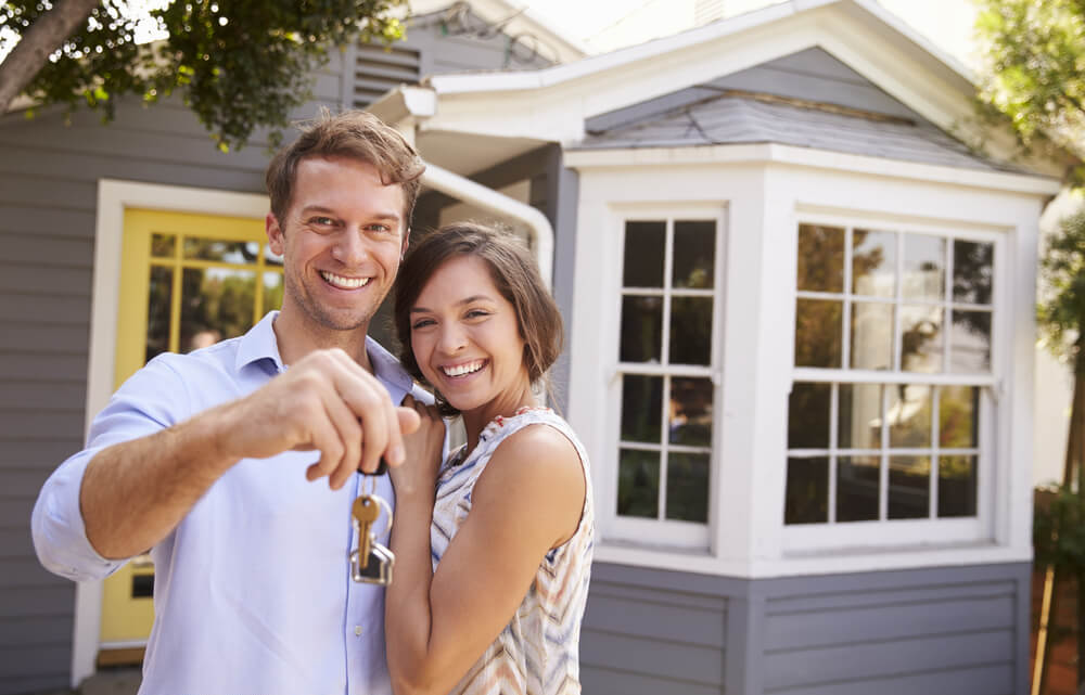 Couple holding keys to new home