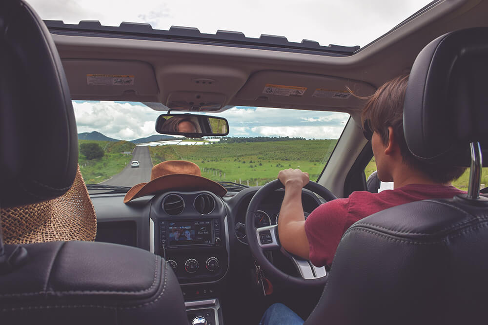 Couple driving in SUV