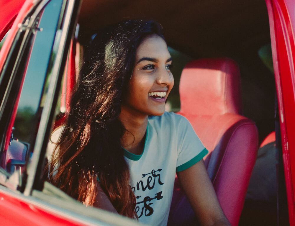 Smiling woman sitting in car