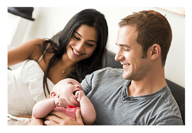 parents holding a baby