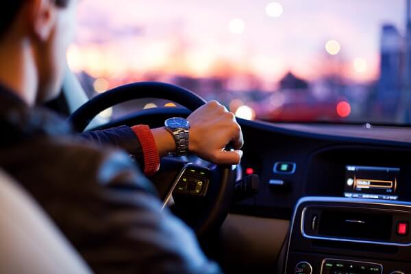 man hand on the driving wheel