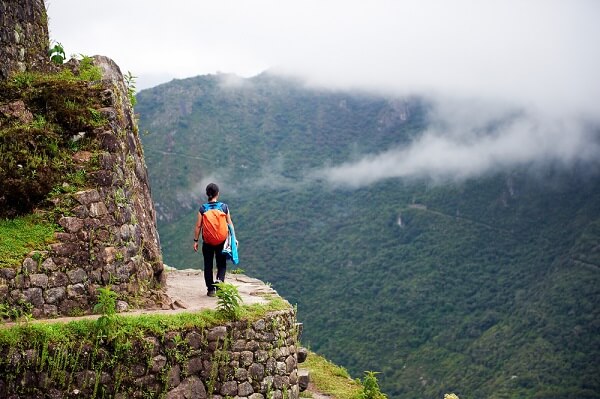 girl walking near the end of a trail in south america