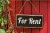 for rent sign on a red wooden door