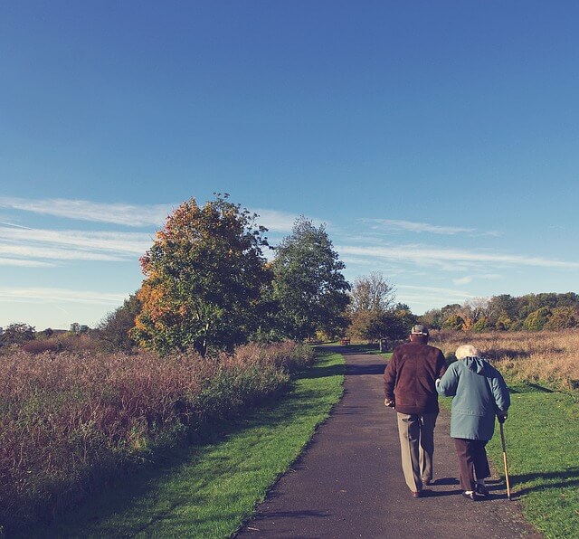 old couple walking down the road