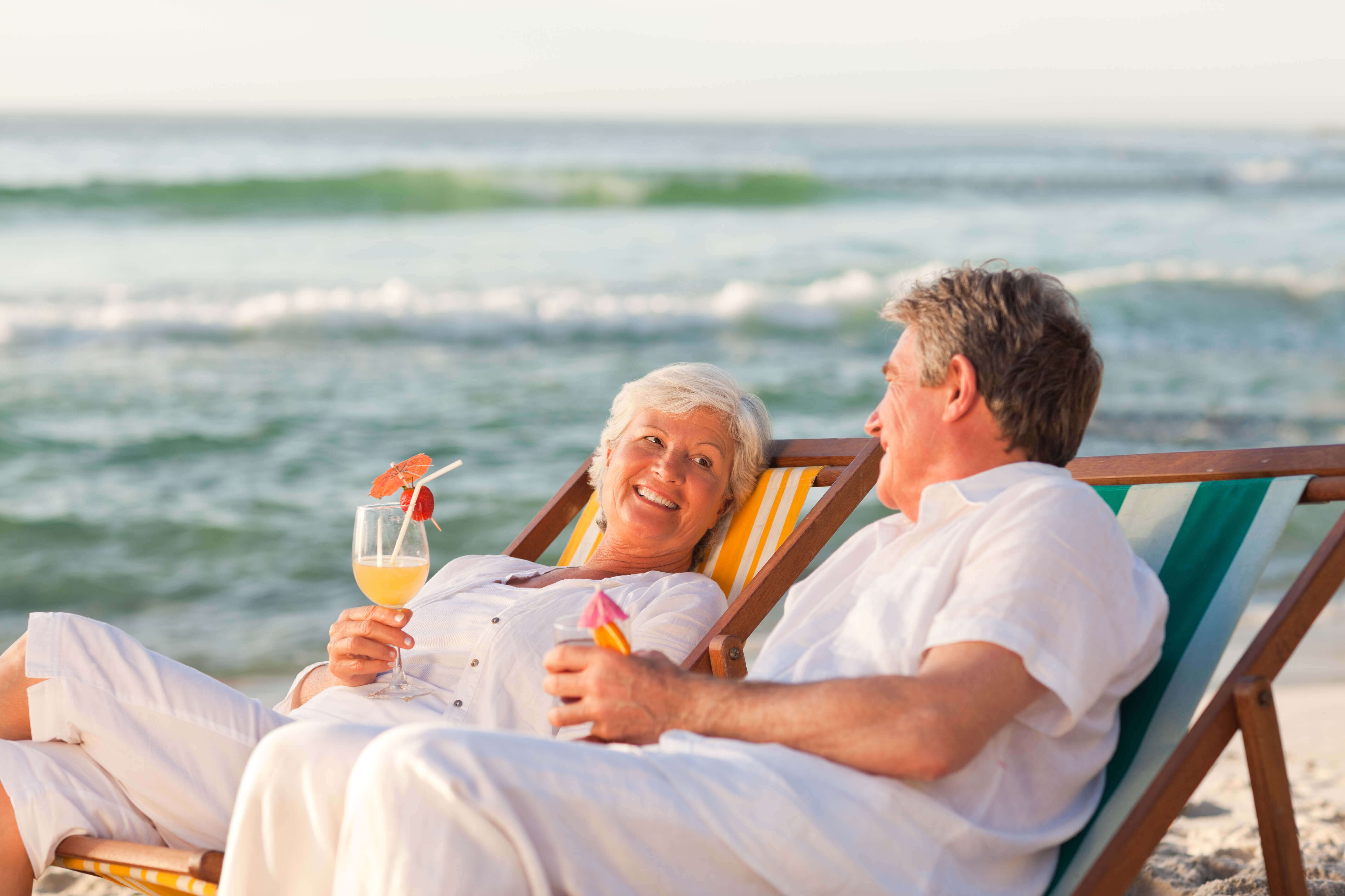 old men and women sitting on the beach