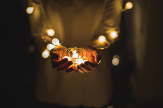 Hands holding lightbulb