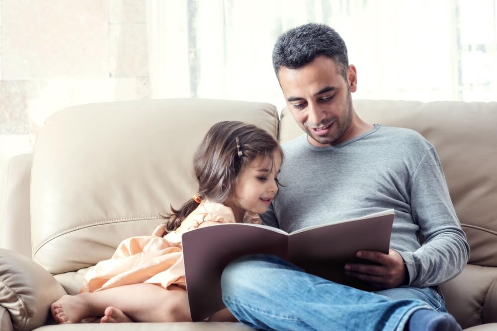 father reading story to daughter