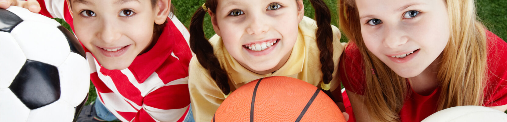 aussie-kids-smiling-and-holding-soccer-ball-and-basketball