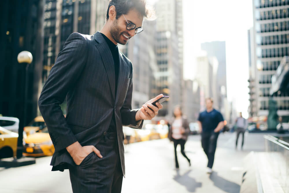 businessman in suit holding phone