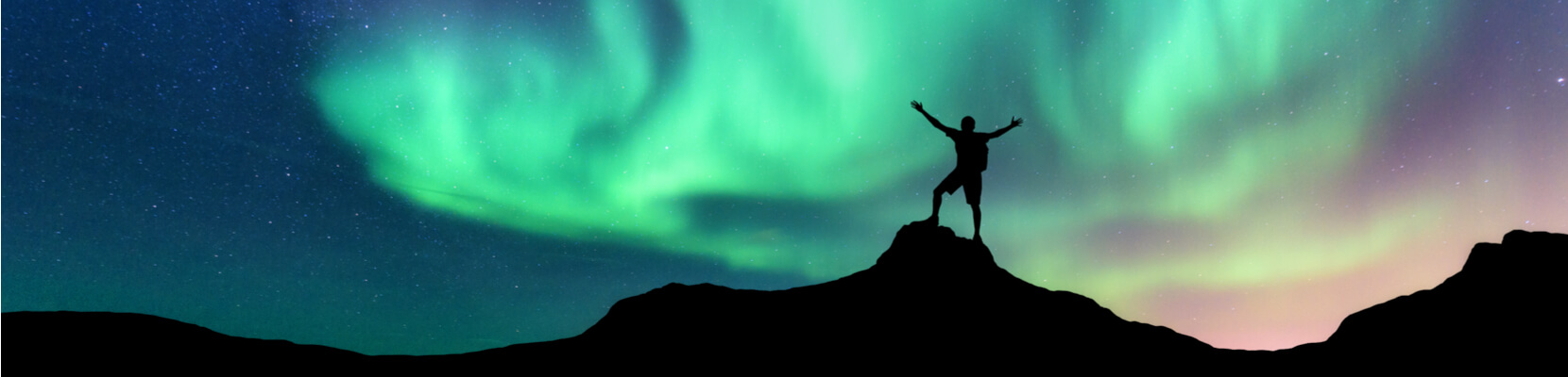 Man looking at northern lights iceland