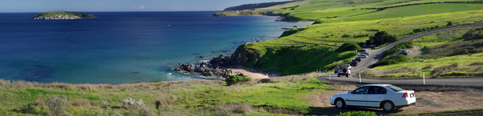 car parked off side of the road along coastline