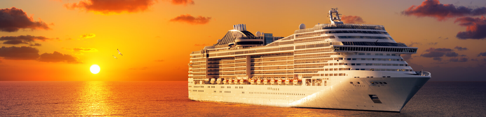 cruise ship at sea during sunset