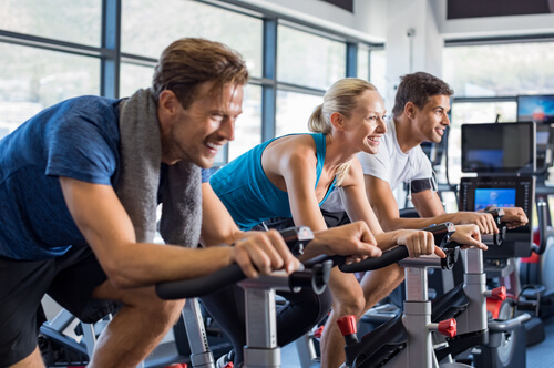 people cycling at the gym