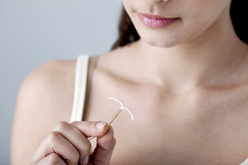 a woman holding an IUD