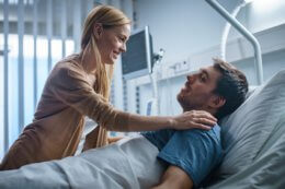 a woman visits a man at hospital