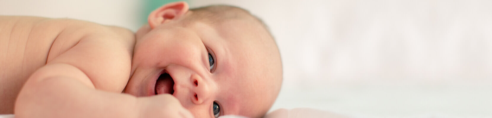 a smiling baby lying down