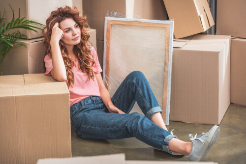 a woman lying down surrounded by boxes