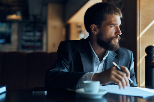 a man in a cafe looking out the window