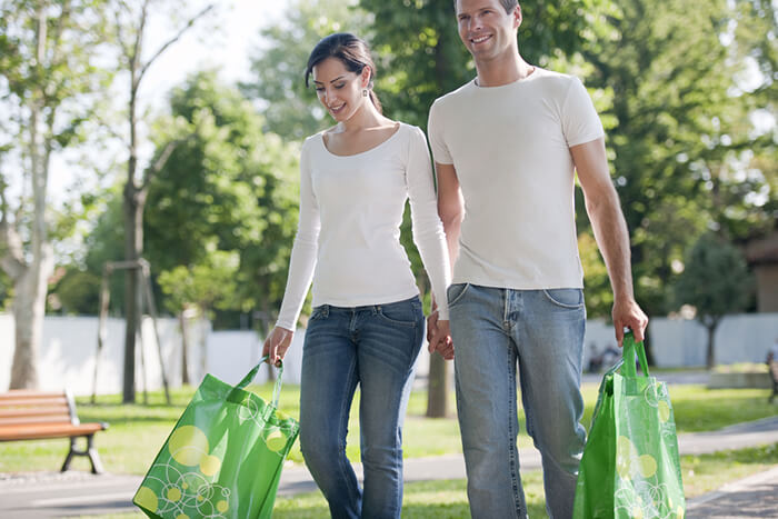 Two adults carrying groceries