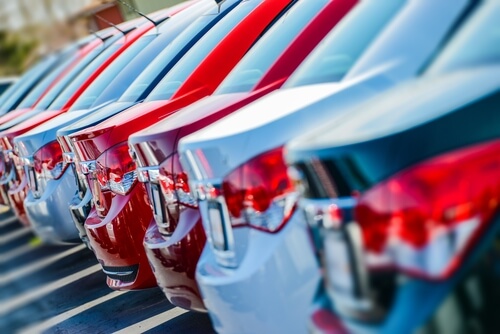 red, white, silver and black cars parked next to each other