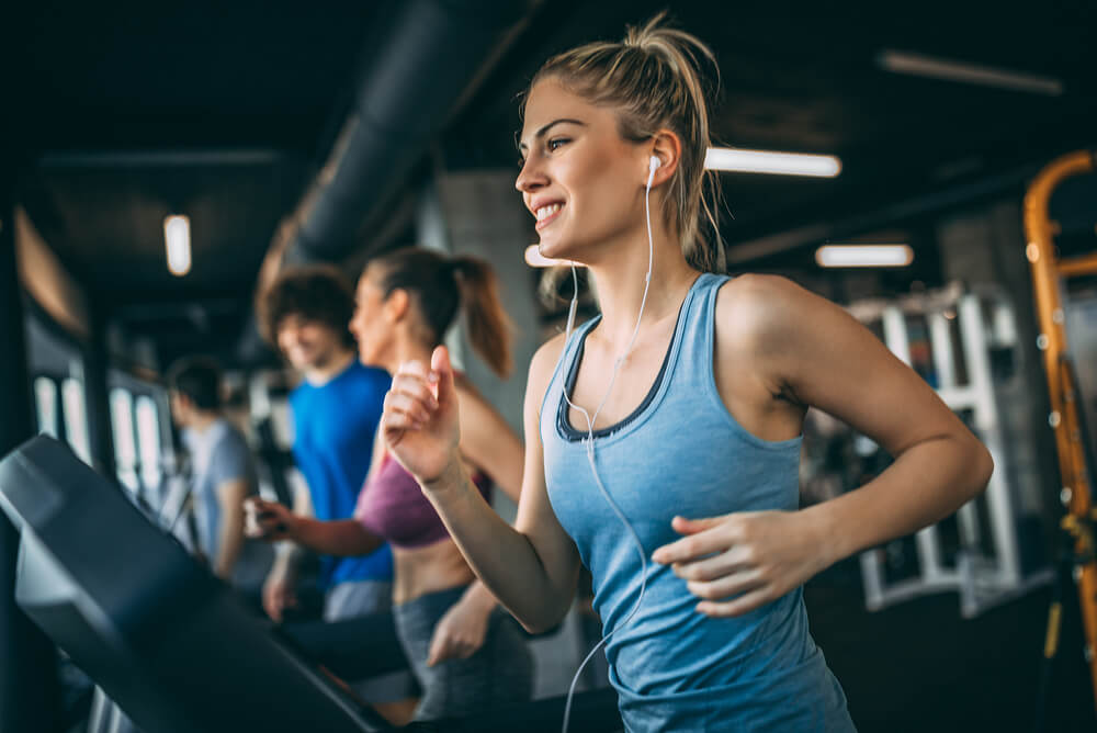 people running on treadmills in a gym