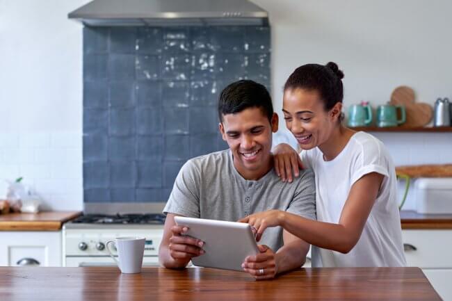 Couple comparing health insurance policies on a tablet