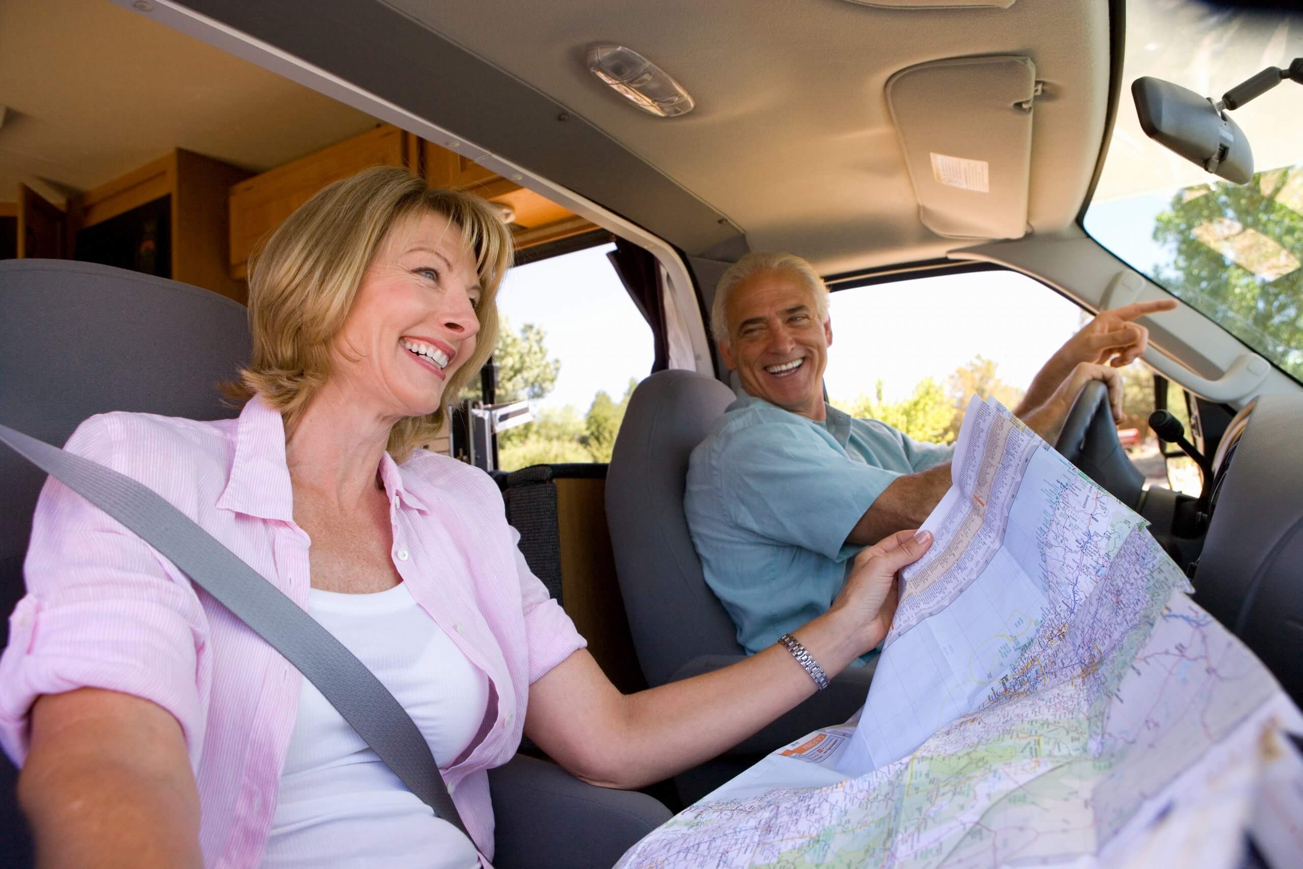 grey nomads driving in a caravan