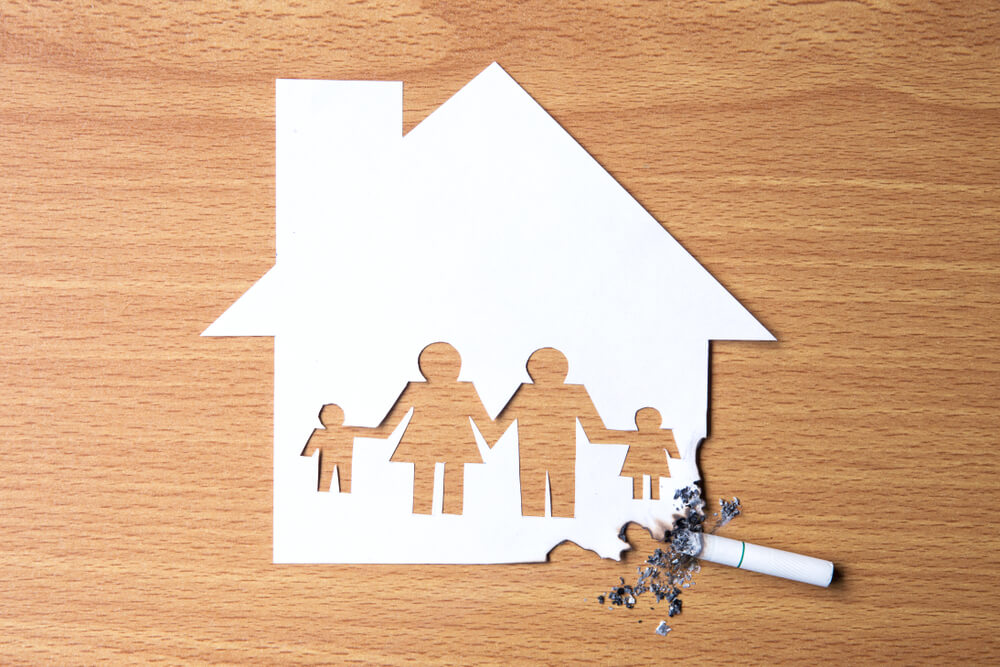 a family home paper cut out damaged by cigarette and residue