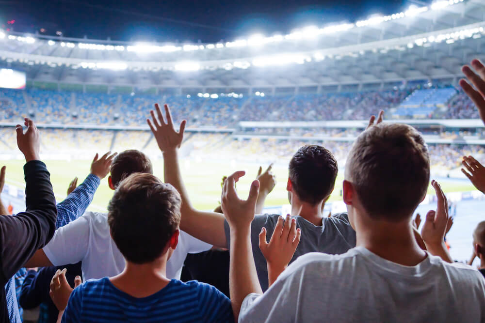 Australian football team fans loudly cheering.