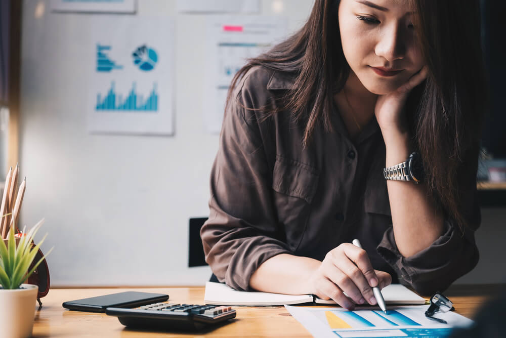 a woman calculating her taxes with private health insurance