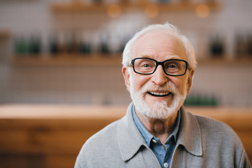 a happy senior man wearing glasses