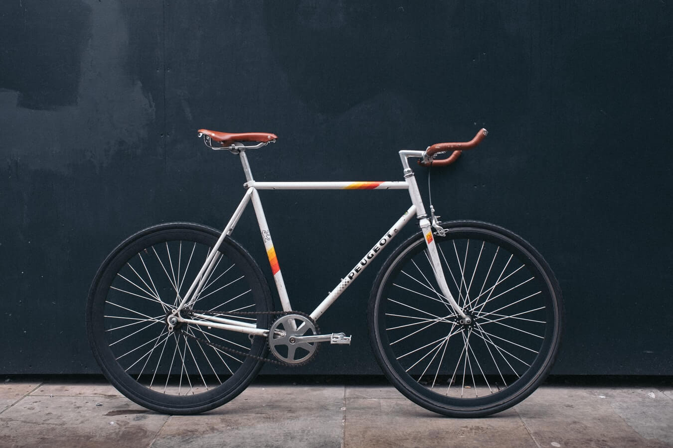 a bicycle against a black wall