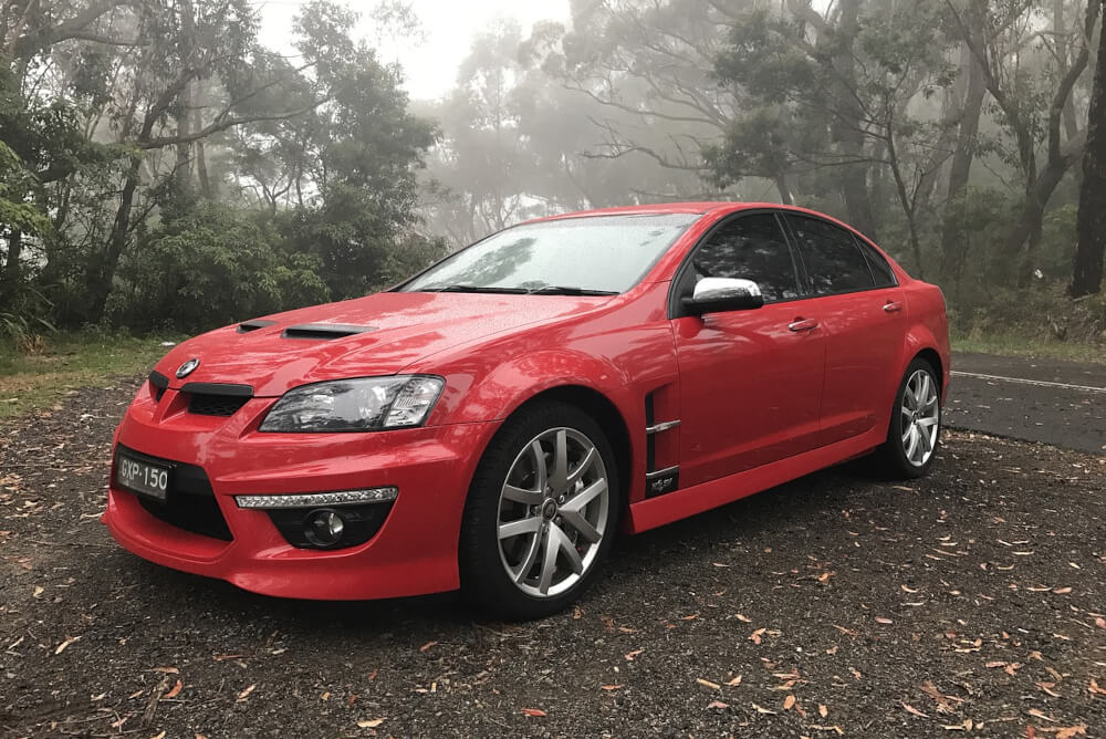 A red Holden on the side of the road.