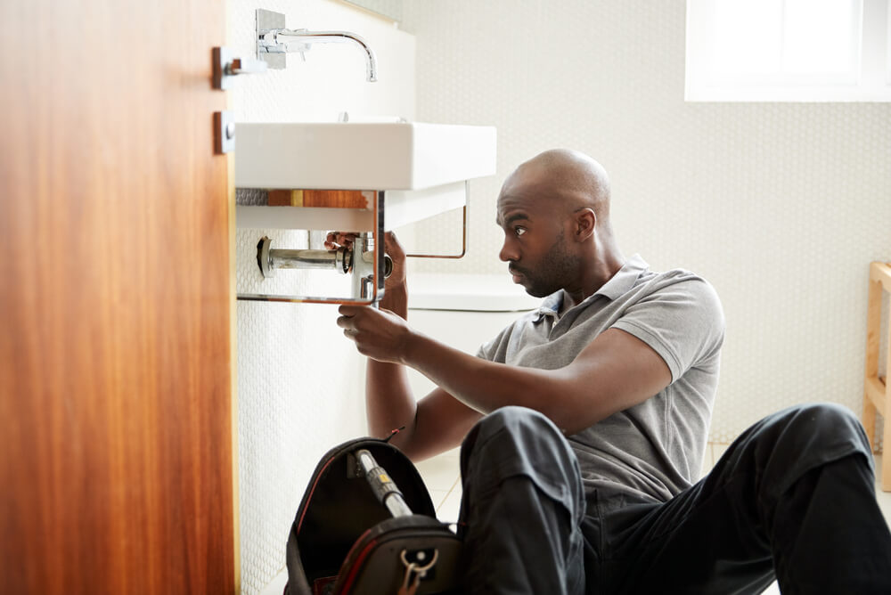 plumber fixing a sink