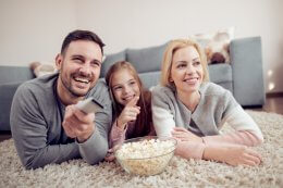 family watching tv they received on the environment appliance offer