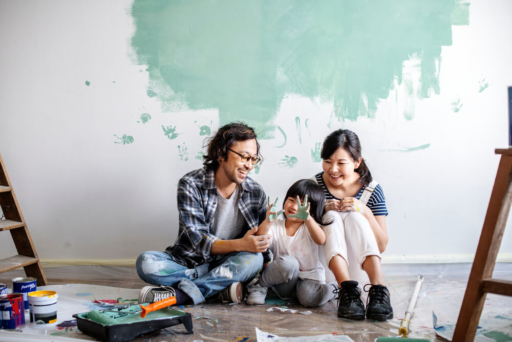 a family painting a wall