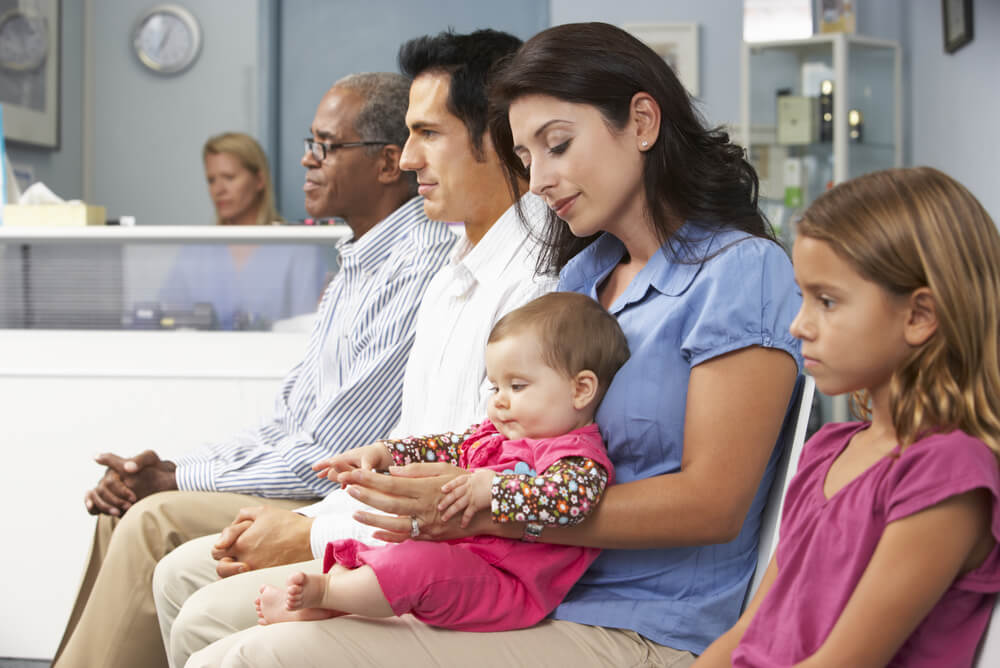 patients sitting in healthcare waiting room before using their extras cover to pay for services