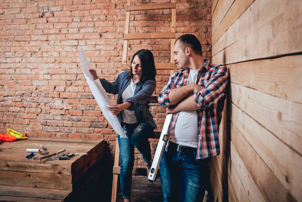 a couple looking at home renovation plans