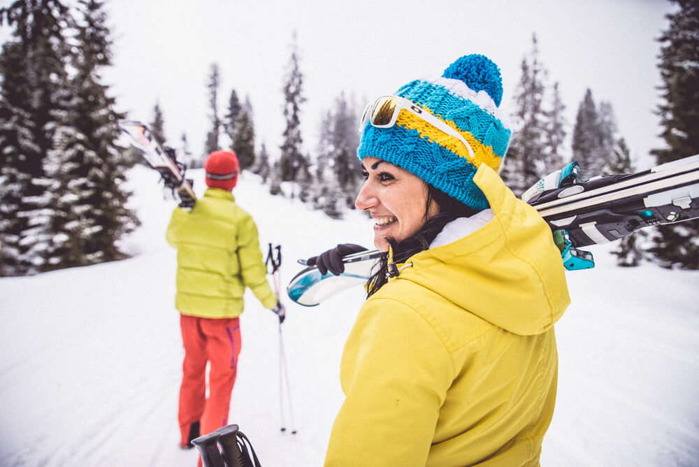 a couple on a ski trip in the snow