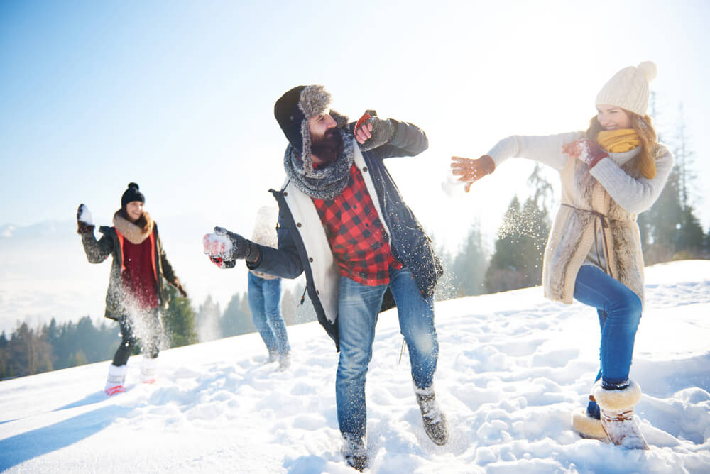 a group of friends having a snowball fight