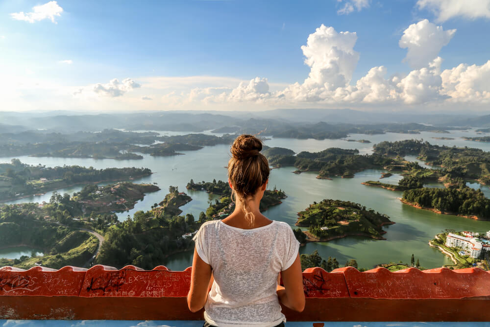 young woman overlooking Guatape in Colombia