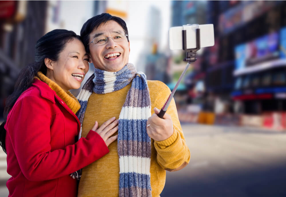 Older couple taking selfie in New York City
