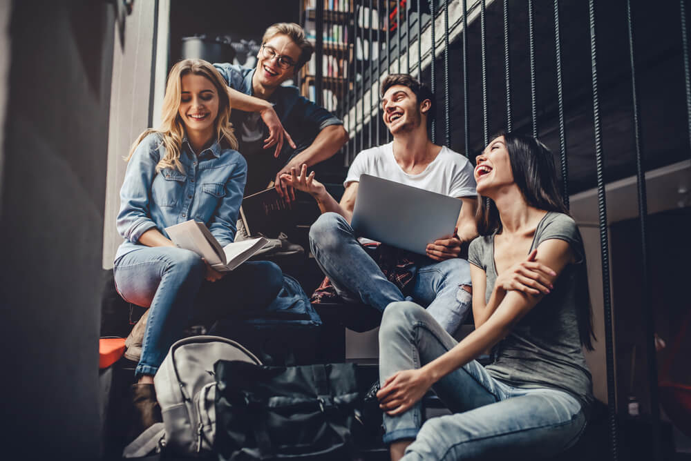 Group of friends comparing student travel insurance