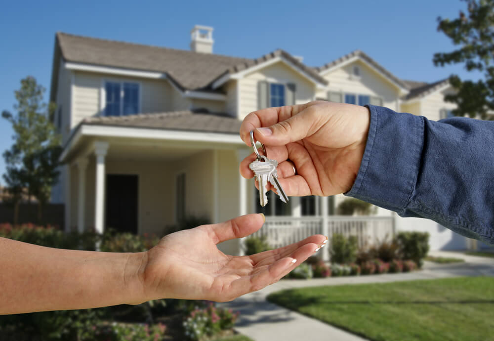 A landlord handing over keys to his house.