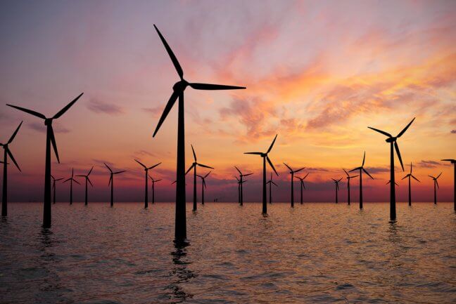 offshore wind turbine at sunset