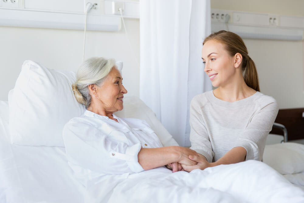 an older woman has a younger female visitor in hospital