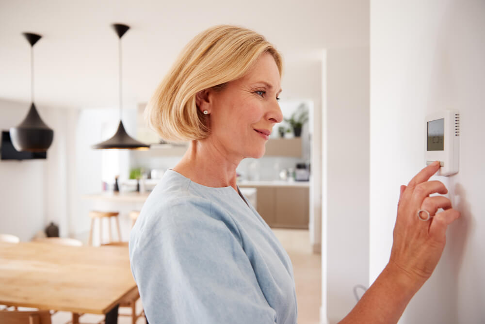 lady controlling her ducted gas heating