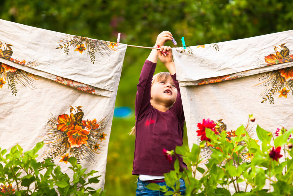 young girl using a washing line