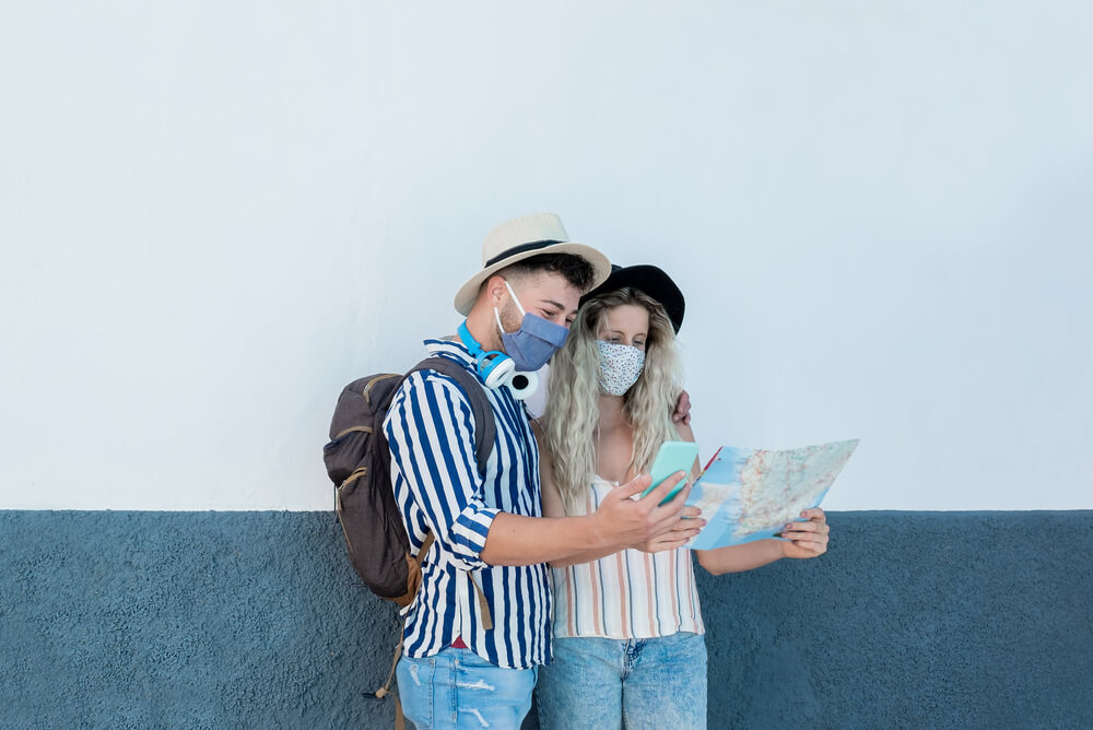 a young couple travelling looking at a map