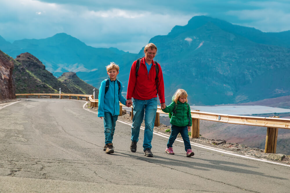 father and children hiking on holiday